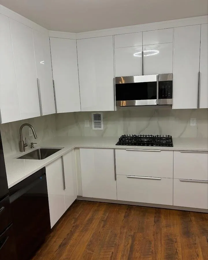 Restored kitchen with white cabinets after water damage in Kula